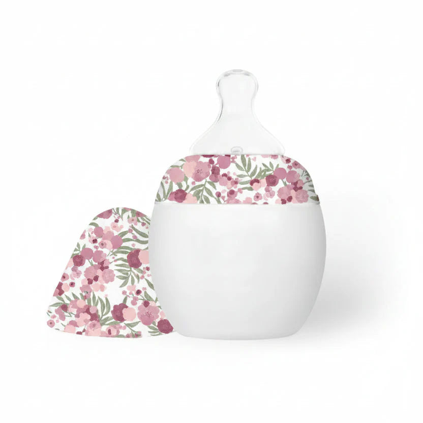 White baby bottle with floral pattern on a white background