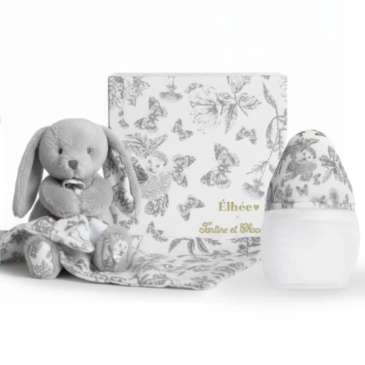 Gray plush bunny toy with a matching blanket and decorative egg on a white background